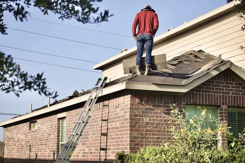 Professional roofer working on a residential roof in Covington